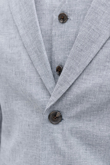 Blazer bleue de PREMIUM by JACK & JONES avec texture tissée subtile et trois boutons marron, gros plan.