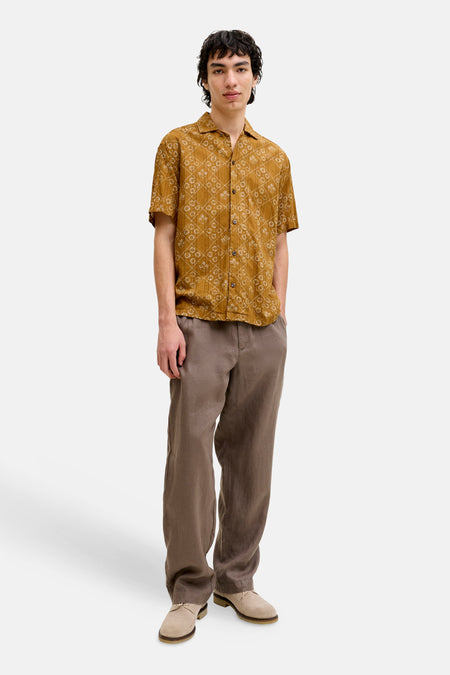 Geel overhemd met korte mouwen van PREMIUM by JACK & JONES, met ruitpatroon, bloemmotieven, bruine broek en beige schoenen.