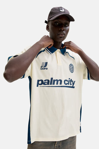 Witte polo met korte mouwen van CORE BY JACK & JONES, met blauwe accenten en 'palm city' print.