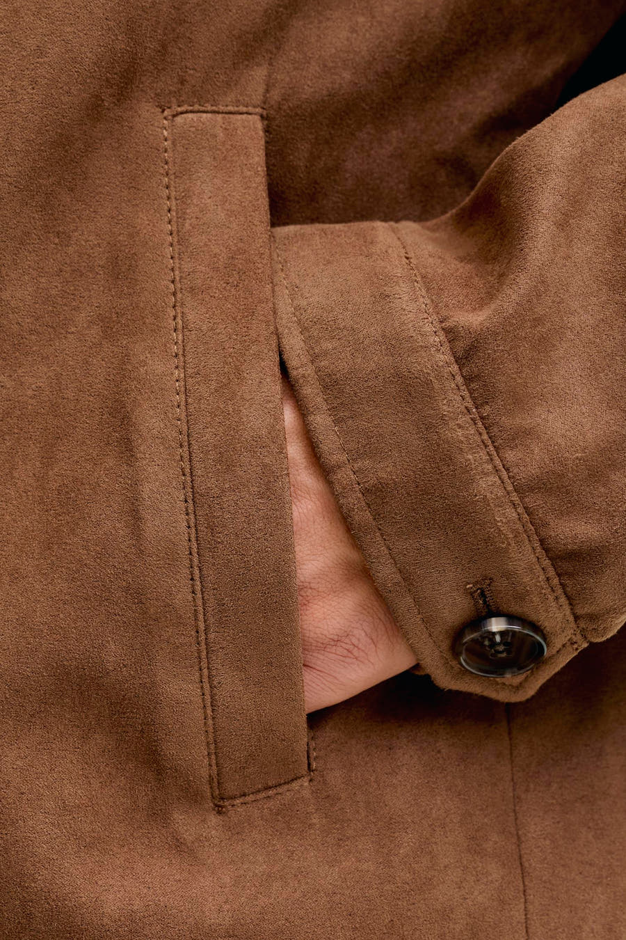 Bruine korte jas van PREMIUM by JACK & JONES, met een hand in de zak en knoopdetails.
