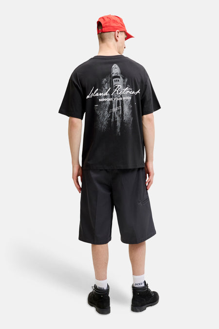 Zwart T-shirt met korte mouwen van CORE BY JACK & JONES, met een grijze grafische print van een jacht en 'Island Retreat' tekst op de rug.