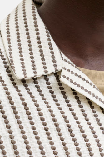 Bruin korte mouwen overhemd van PREMIUM by JACK & JONES met witte stof en bruine stippenpatroon, close-up van kraag en bovenlijf