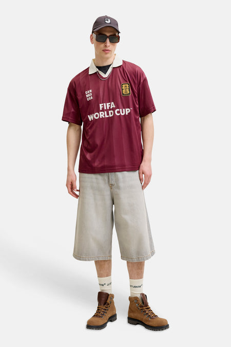 Bordeauxrode polo van ORIGINALS BY JACK & JONES met verticale strepen, witte kraag, FIFA World Cup opdruk, badge en 'CAN MEX USA' tekst.