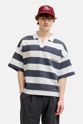 Multicolor gestreepte sweater met ronde hals van ORIGINALS BY JACK & JONES, gecombineerd met een witte polo kraag, goudkleurige tekst en logo op de borst, gedragen met een rode pet en donkere broek, front view.