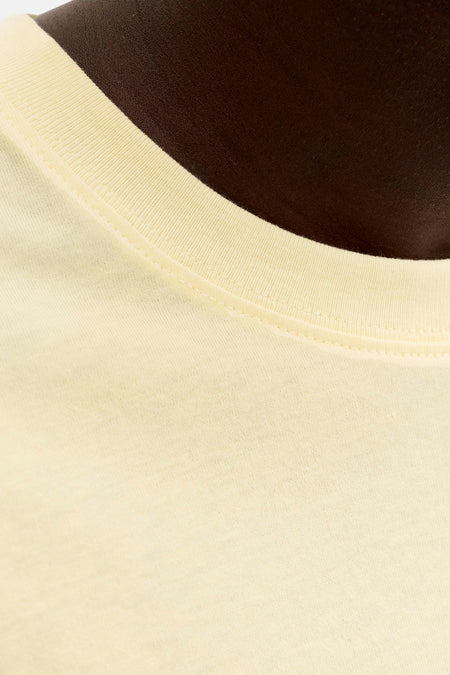 T-shirt jaune de ORIGINALS BY JACK & JONES, gros plan sur l'encolure côtelée et le tissu doux sur peau foncée.