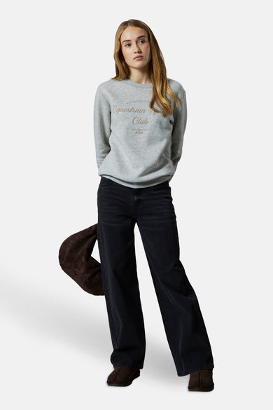 Zwarte wijde jeans van LMTD, met bruine tas en bruine schoenen.