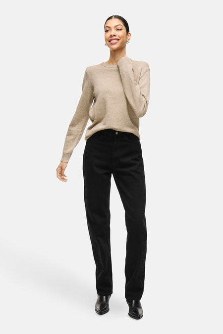 Beige trui met ronde hals van VILA, gedragen met een zwarte broek en zwarte schoenen.