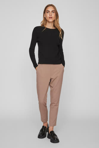 Zwarte trui met ronde hals van VILA®, gecombineerd met beige pantalon en zwarte loafers.
