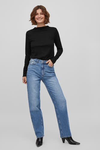 Jean droit en denim bleu de VILA, associé à une chemise noire à manches longues et des bottes noires.