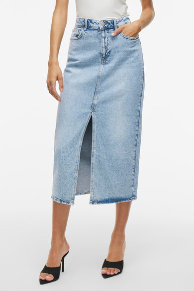 Lichtblauwe denim rok van VILA met split aan de voorkant, gecombineerd met zwarte hakken.
