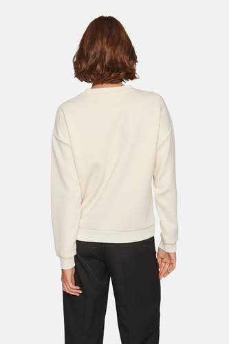 Gilet beige avec col rond de VILA®, vu de l'arrière, associé à un pantalon noir.
