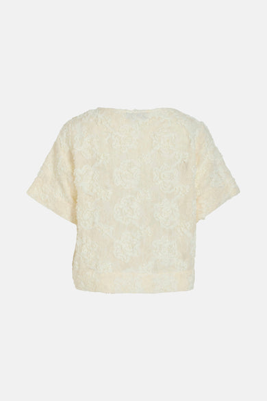 Beige blouse met korte mouwen van VILA®, met een subtiel bloemmotief en zachte textuur.
