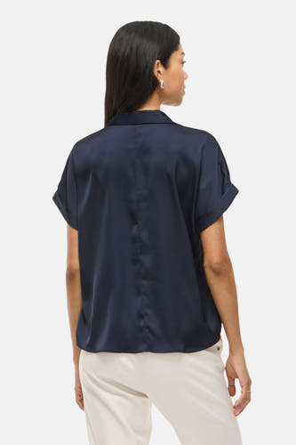 Blauwe blouse met korte mouwen van VILA, gezien van achteren, met een kraag en beige pantalon.

