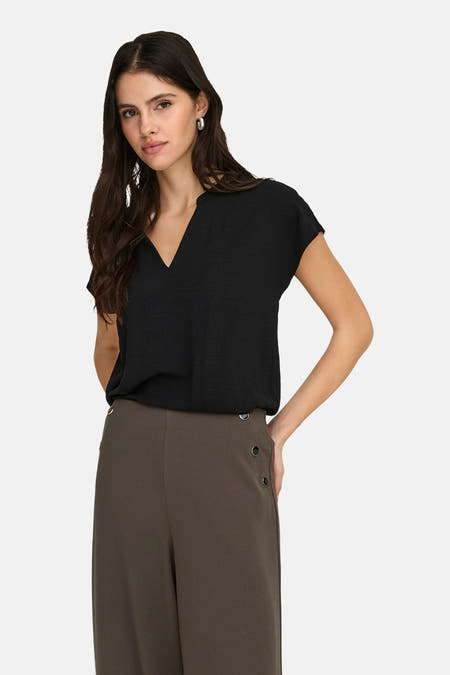 Zwarte blouse van JDY met korte mouwen en een V-hals, gedragen met een kaki broek.