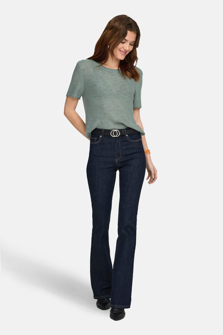 Groene trui van ONLY, met korte mouwen, gecombineerd met donkere jeans met een zwarte riem.
