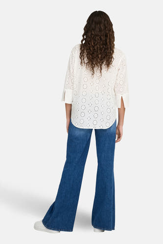 Wit overhemd met lange mouwen van JDY, met ajourdetails, gedragen met blauwe jeans.