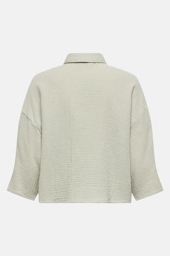 Blouse en coton vert clair à manches courtes.