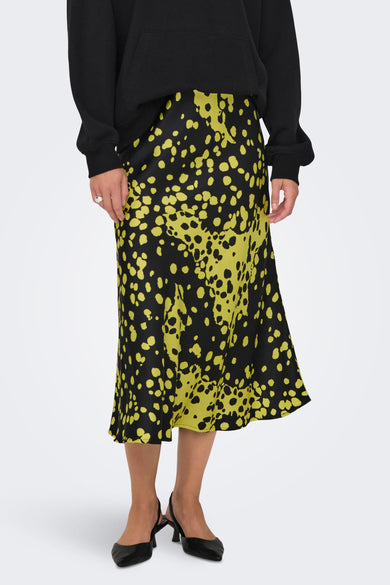 Geel/zwarte rok van ONLY, met geprint stippenpatroon en gedragen met een zwarte hoodie en slingback pumps.
