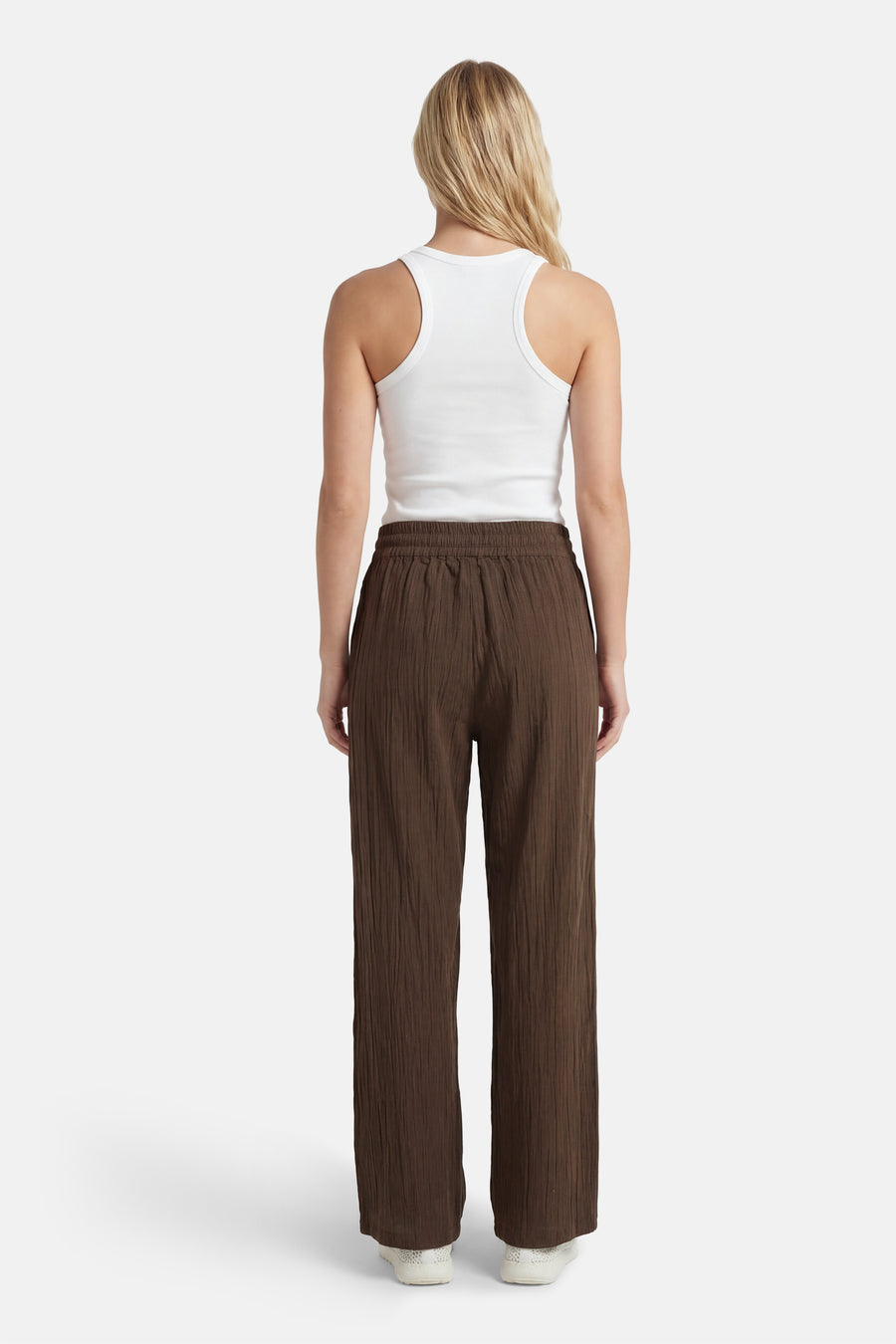 Pantalon marron de ONLY, avec une texture froissée, combiné avec une chemise blanche.