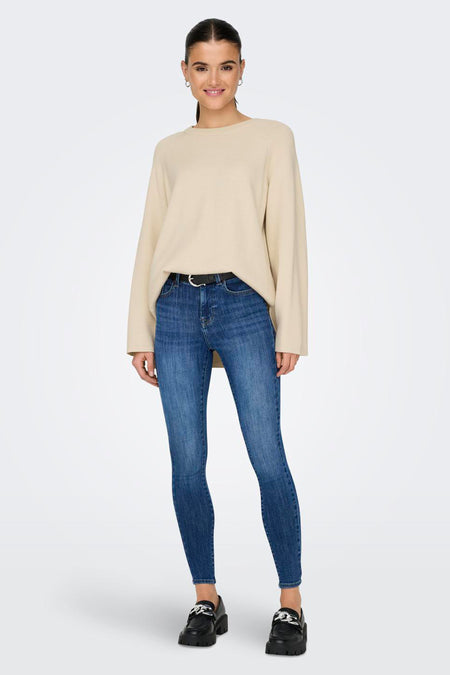 T-shirt écru avec col rond de ONLY, associé à des jeans bleus et des chaussures noires.