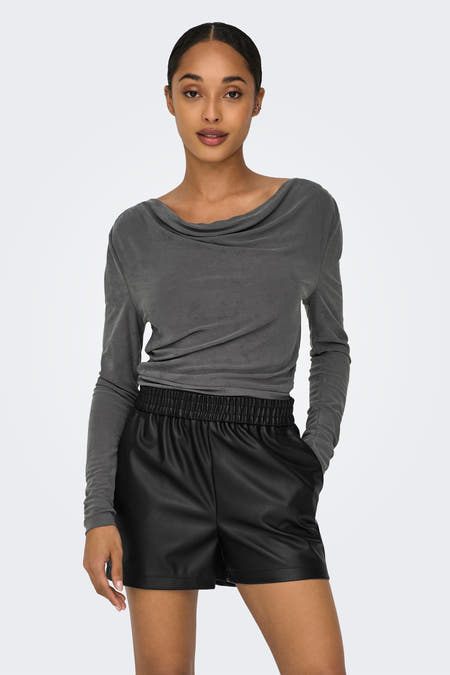 Grijze T-shirt met lange mouwen van ONLY, met gedrapeerde halslijn en gedragen met een zwarte leren short.
