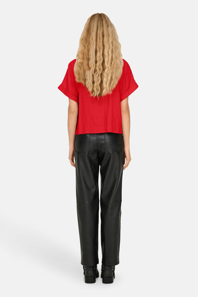 Rood hemd met korte mouwen van ONLY, met omslagdetail aan de mouw. Zwarte lederlook broek en zwarte laarzen.