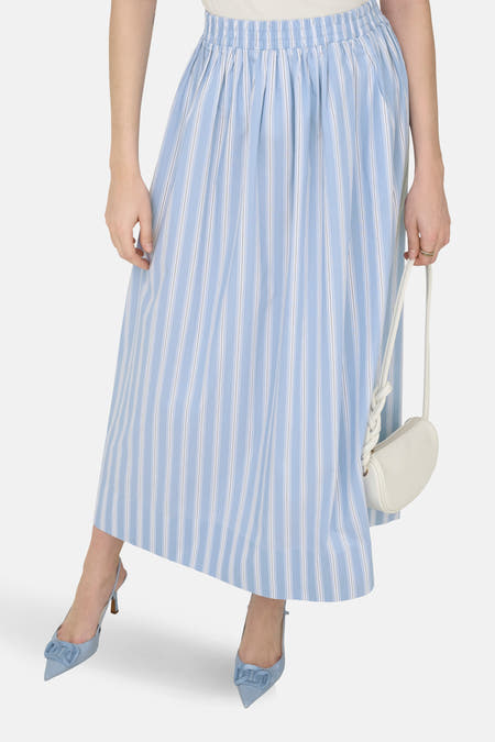 Blauwe rok van JDY, met krijtstreep en details van een witte handtas en blauwe schoenen.