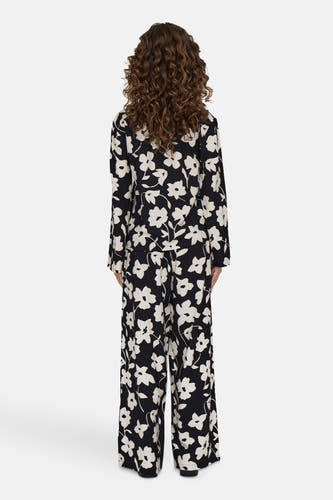 Blouse noire à manches longues de JDY, avec un motif de fleurs blanches sur toute la blouse.