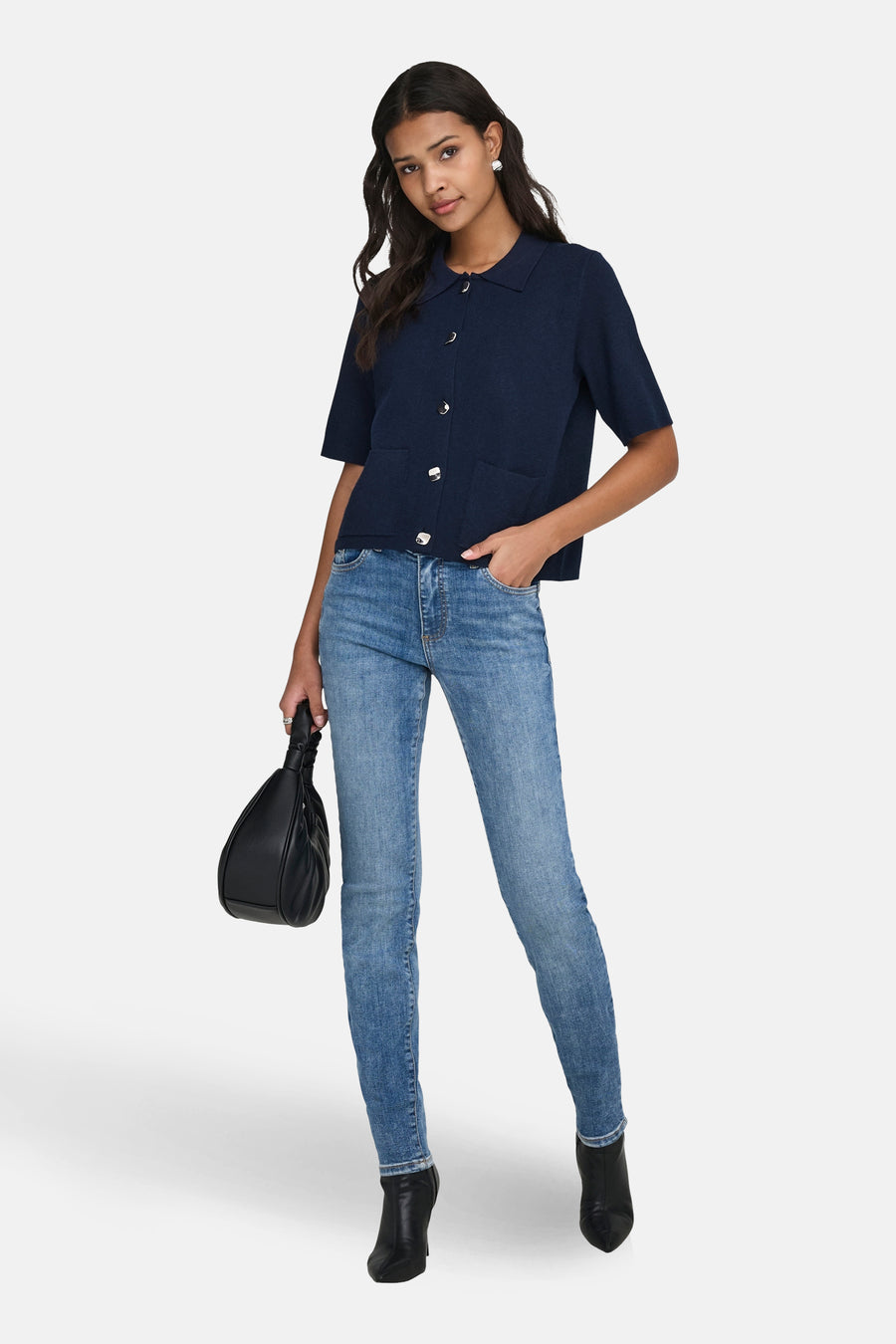 Blauw gilet van JDY, met zilveren knopen en opgestikte zakken, gecombineerd met jeans en zwarte laarsjes.