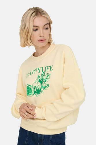 Gilet écru de ONLY avec une impression verte de figues et le texte 'Happylife'.