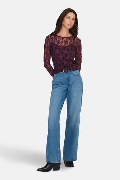 Bordeaux T-shirt met lange mouwen van ONLY®, met kanten details en gecombineerd met een blauwe jeans met rechte pijpen.