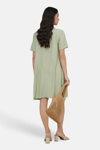 Robe verte à manches courtes de JDY, avec une texture aspect lin, associée à des sandales à talons et un sac.