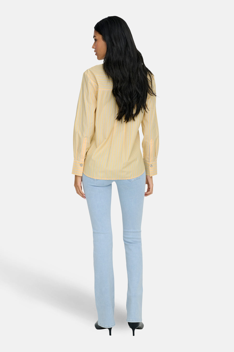 Geel, gestreept overhemd met lange mouwen van JDY, gezien van achteren, met lange mouwen en lichte jeans.
