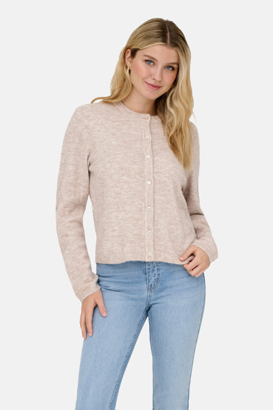 Veste beige ONLY, à boutons, associée à un jean bleu et des loafers marron foncé.