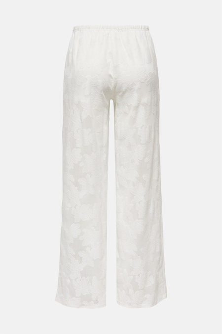 Witte broek van ONLY, met een subtiel bloempatroon en een comfortabele elastische tailleband, gezien van achteren.
