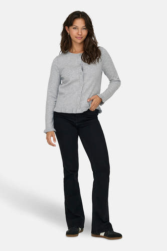 Grijze cardigan van ONLY, met lange mouwen en knoopsluiting, gecombineerd met een zwarte broek en sneakers.
