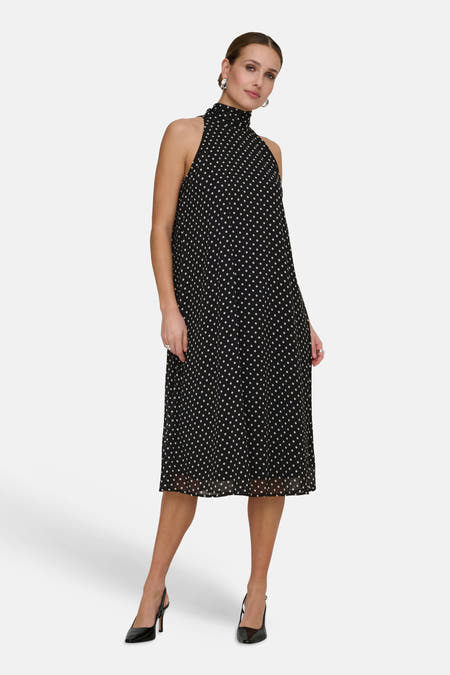 Robe sans manches noire de JDY à pois blancs, col montant et coupe évasée.