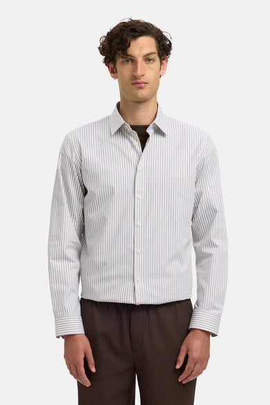 Wit gestreept overhemd (lange mouwen) van SELECTED, met bruine broek eronder.