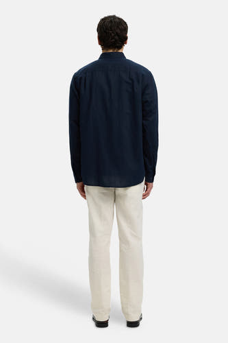 Blauw hemd met lange mouwen van SELECTED, van achteren gezien met lichte broek.