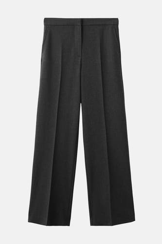 Pantalon de costume gris MANGO, avec des jambes larges et des poches.