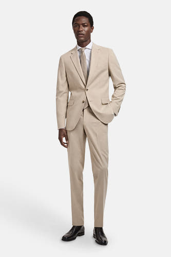 Beige blazer van MANGO, met bijpassende broek, wit overhemd en bruine stropdas.
