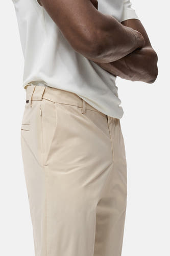 Ecru broek van MANGO, met zijzak en subtiele plooien, gecombineerd met een wit shirt.