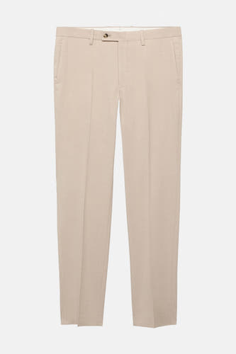 Beige kostuumbroek van MANGO, met een subtiele textuur en een klassieke pasvorm.
