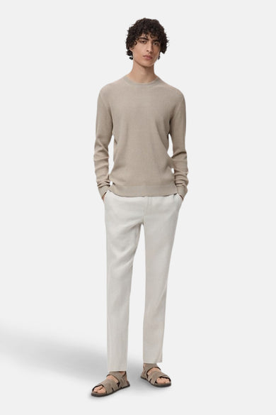 Gilet beige avec col rond de MANGO, complet avec des manches longues et une fine structure en côtes.
