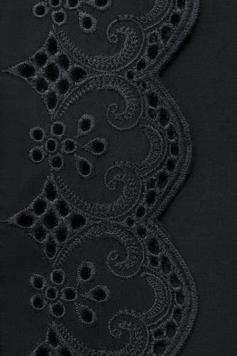 Lange zwarte rok van MANGO, met verfijnd broderie anglaise detail aan de zoom.
