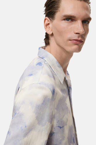 Meerkleurig overhemd met korte mouwen van MANGO, met een wazig blauw en beige patroon, in zij-aanzicht.
