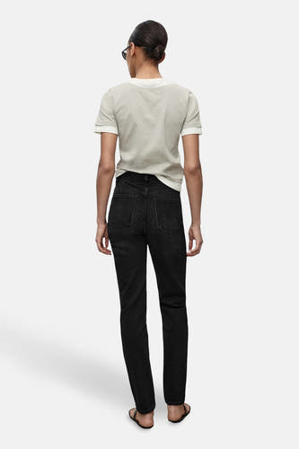 Donkergrijze mom jeans van MANGO, gezien van achteren, gecombineerd met een lichtgrijs T-shirt.