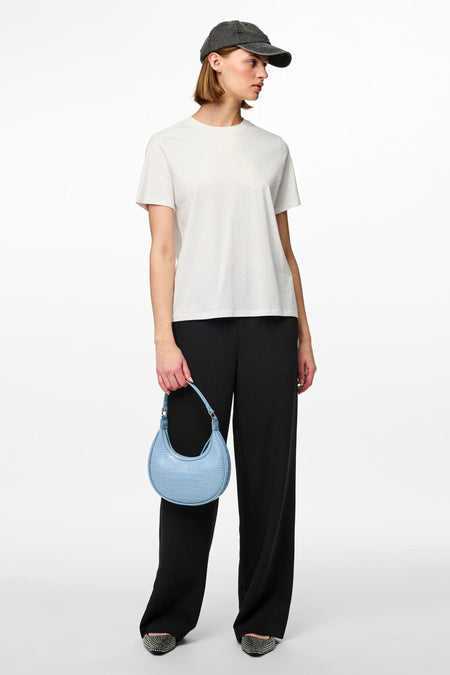 Zwarte joggingbroek van PIECES®, gedragen met een wit T-shirt en een blauwe handtas.
