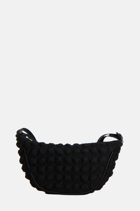 Sac à dos noir de PIECES®, avec une texture imprimée et une forme de lune.