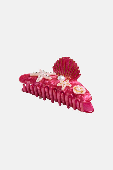 Pince à cheveux rose de PIECES® avec décorations de coquillages, étoiles de mer et perles.